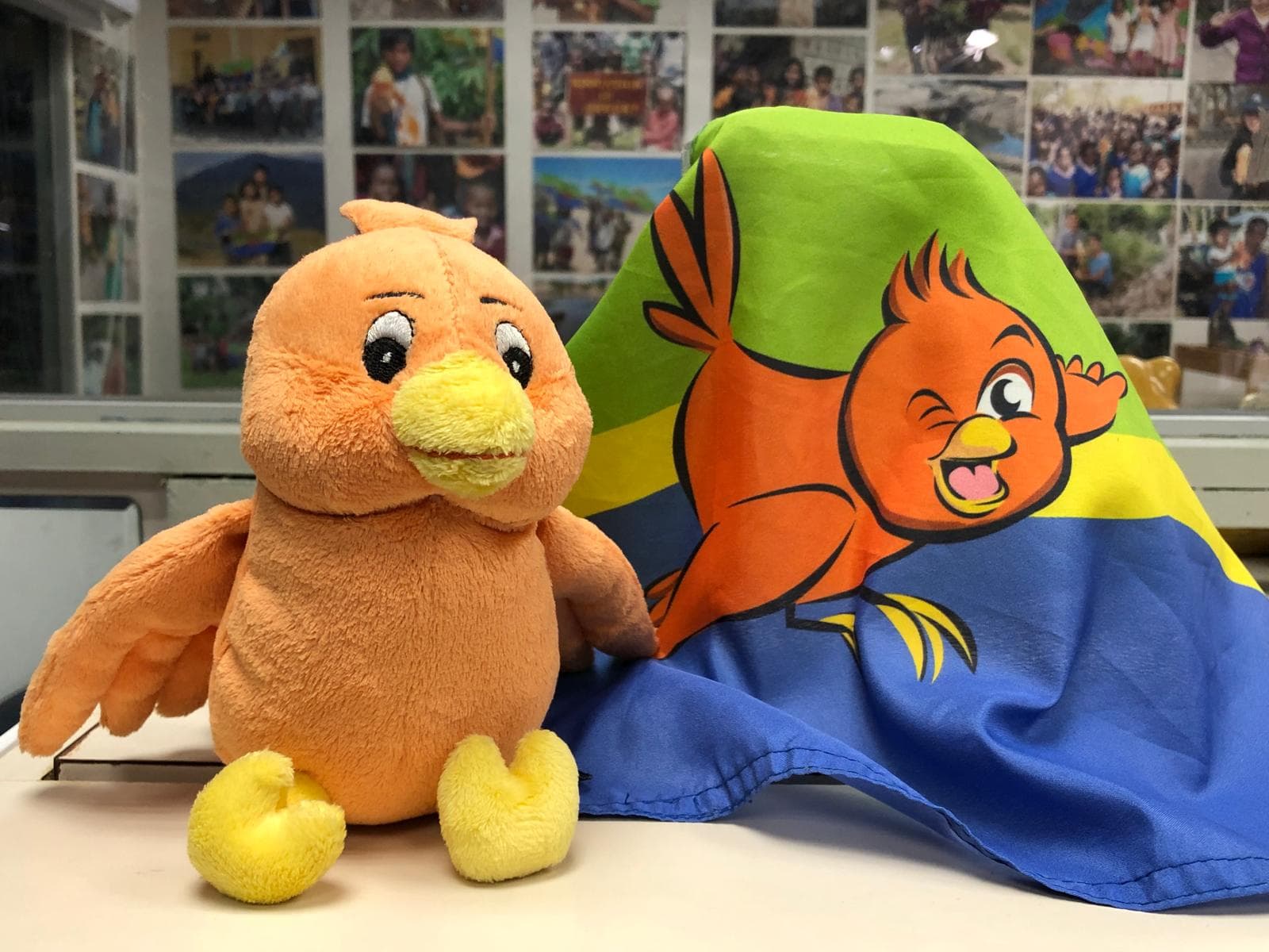 Boopy plush mascot with the Boopy & flag tapestry